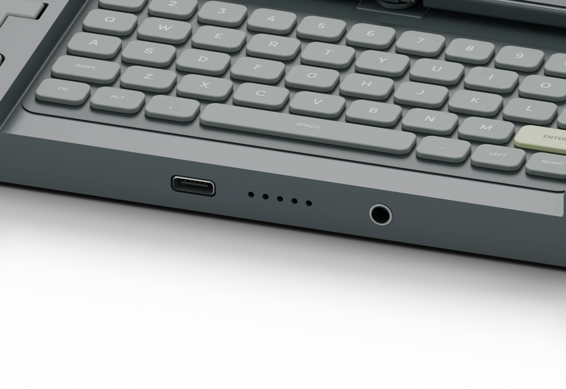 Close design render of the keyboard edge, showing proposed USB-C and headphone openings.